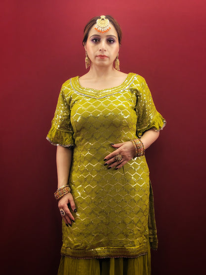 Embrace elegance with a mehendi green sharara set, featuring a dazzling sequins work and a beads & zari embellished neckline, crafted from luxurious chinnon fabric for a quintessential Indian ethnic wear ensemble.