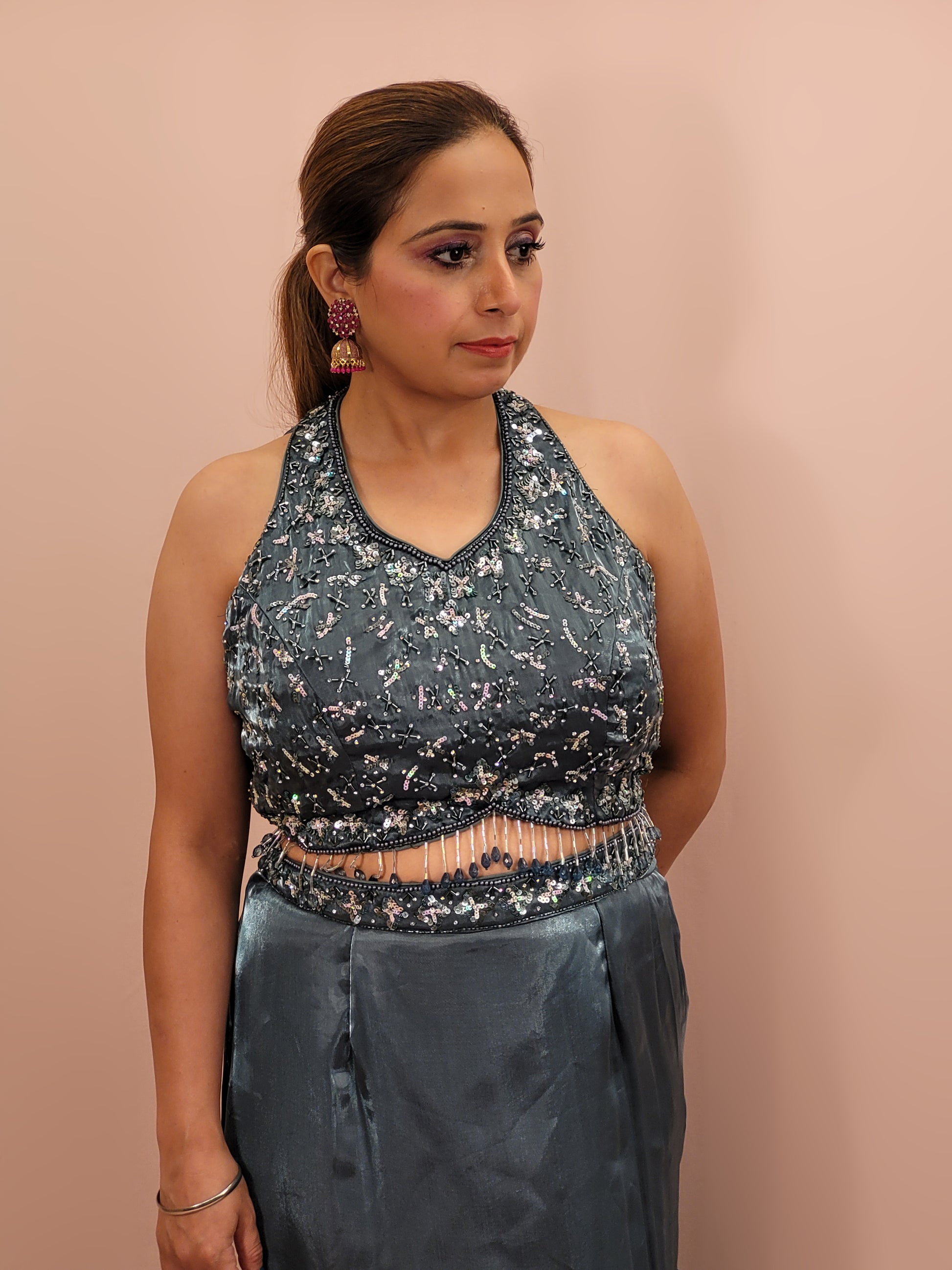 Elevate your ethnic wardrobe with this stunning Steel Blue Ready to Wear Drape Saree, crafted from luxurious Jimmy Choo fabric. This exquisite saree features a fish cut mermaid style skirt that beautifully accentuates your silhouette, flowing into a flared hem for a dramatic effect. The ensemble is completed with a hand work blouse, intricately adorned with shimmering sequins and delicate beads, adding a touch of glamour to your look.