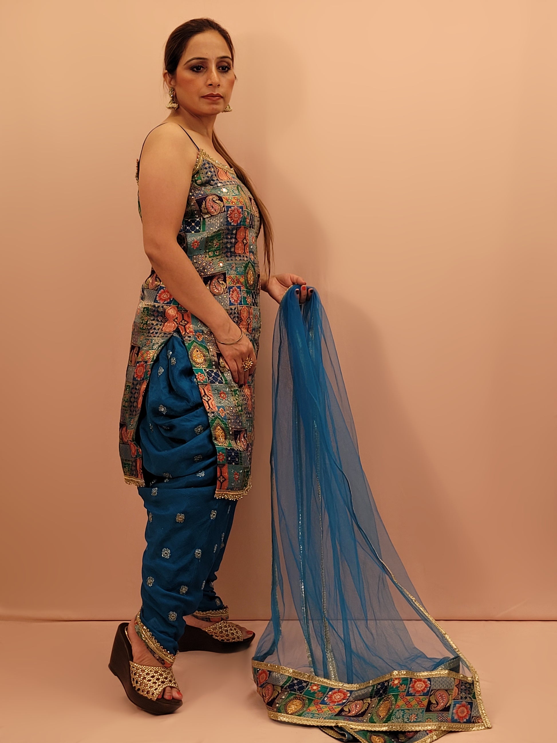 Fabric:&nbsp;Luxurious blue fabric with a vibrant Banarasi multicolor position weave on the kameez.
Kameez:&nbsp;Adorned with intricate Banarasi multicolor position weave, creating an enchanting tapestry of rich hues and patterns.
Pants:&nbsp;Matching embroidered tulip pants that add a modern twist to the classic silhouette.
Dupatta:&nbsp;Delicate net dupatta that drapes gracefully, adding an extra layer of sophistication.