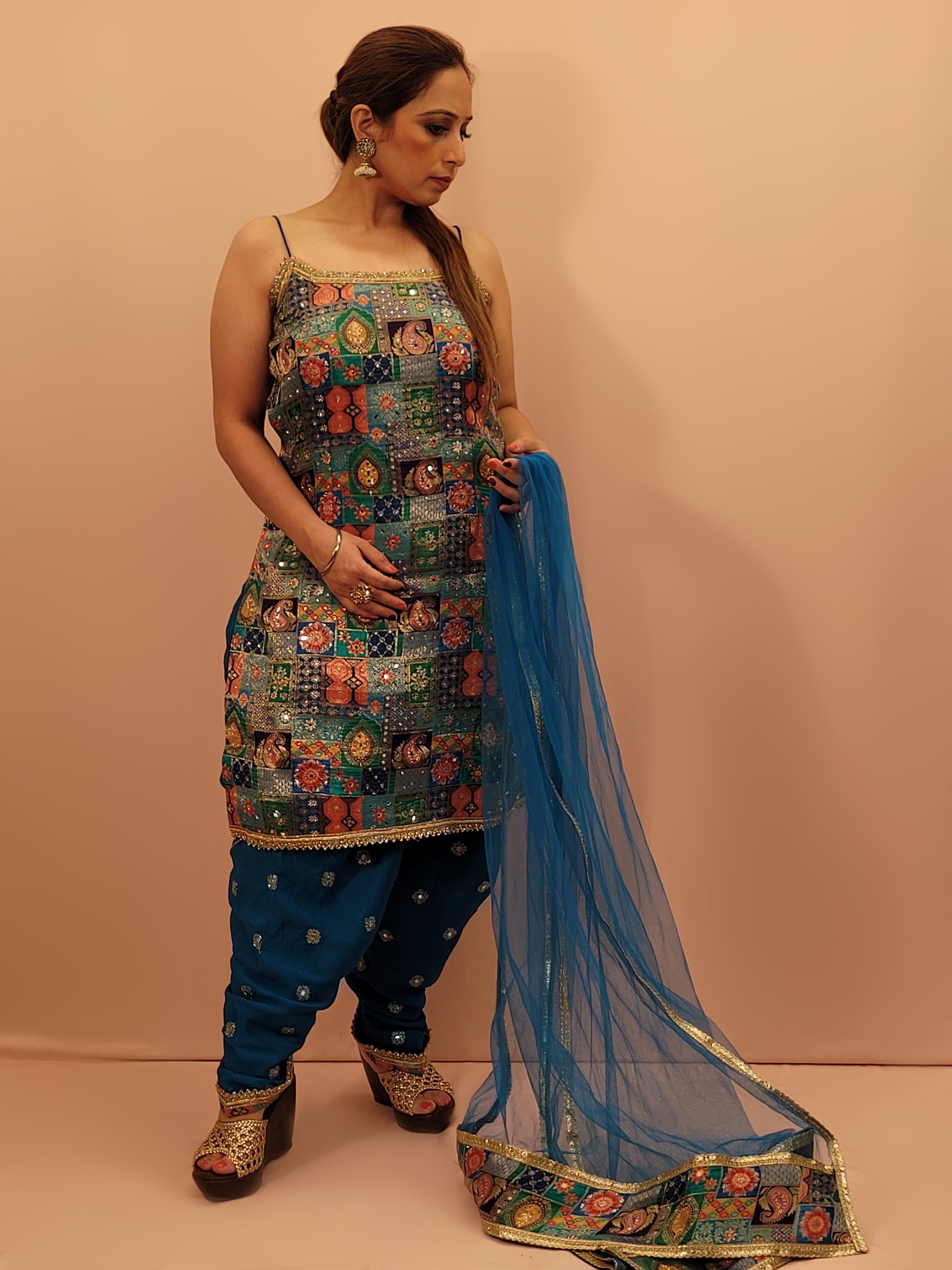 Fabric:&nbsp;Luxurious blue fabric with a vibrant Banarasi multicolor position weave on the kameez.
Kameez:&nbsp;Adorned with intricate Banarasi multicolor position weave, creating an enchanting tapestry of rich hues and patterns.
Pants:&nbsp;Matching embroidered tulip pants that add a modern twist to the classic silhouette.
Dupatta:&nbsp;Delicate net dupatta that drapes gracefully, adding an extra layer of sophistication.