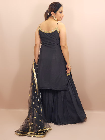 Black Sharara Suit, crafted from luxurious chinnon fabric that offers a beautiful sheen and soft drape. This ensemble is perfect for festive occasions, weddings, and celebratory events, ensuring you stand out with grace and style.