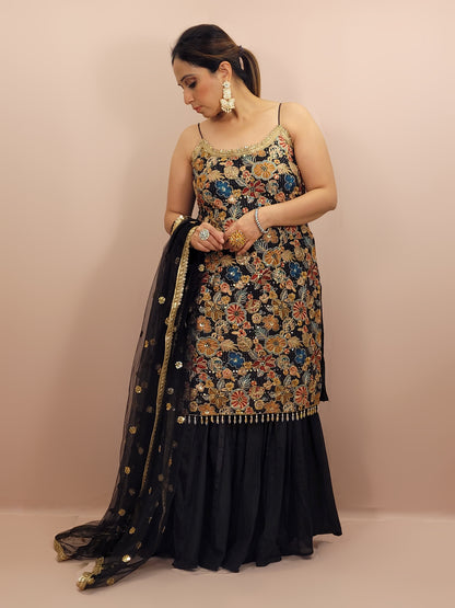 Black Sharara Suit, crafted from luxurious chinnon fabric that offers a beautiful sheen and soft drape. This ensemble is perfect for festive occasions, weddings, and celebratory events, ensuring you stand out with grace and style.
