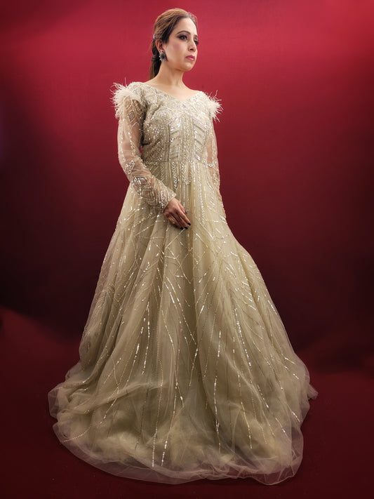 Imagine an Indian marriage dress in pista green, a symphony of beads, sequins and zarkan work, with a touch of luxury added by fur trimmed embroidered sleeves, all set against a backdrop of sheer net, perfect for engagement and reception festivities.