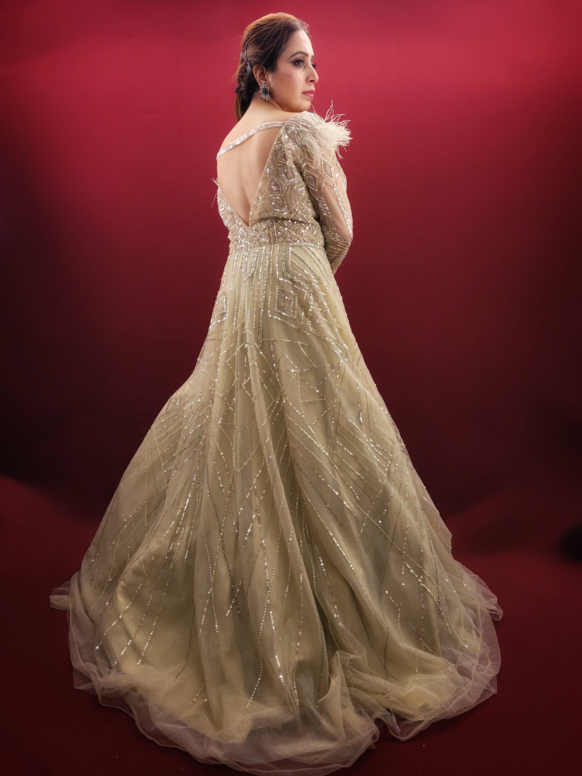 Imagine an Indian marriage dress in pista green, a symphony of beads, sequins and zarkan work, with a touch of luxury added by fur trimmed embroidered sleeves, all set against a backdrop of sheer net, perfect for engagement and reception festivities.