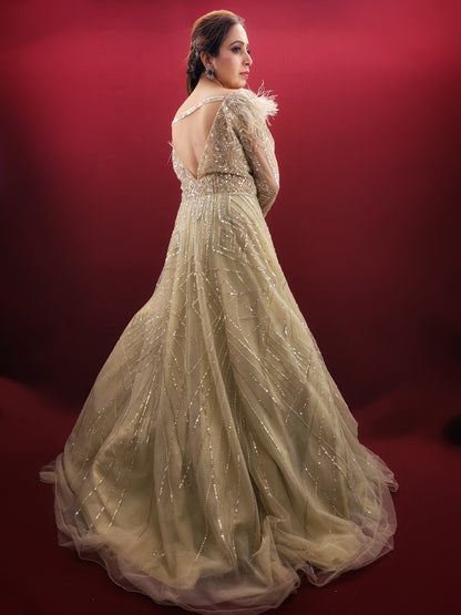 Imagine an Indian marriage dress in pista green, a symphony of beads, sequins and zarkan work, with a touch of luxury added by fur trimmed embroidered sleeves, all set against a backdrop of sheer net, perfect for engagement and reception festivities.