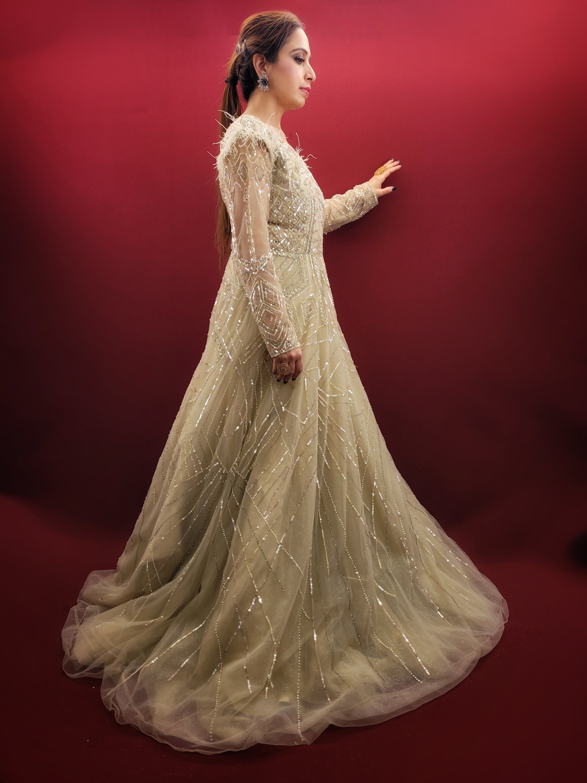 Imagine an Indian marriage dress in pista green, a symphony of beads, sequins and zarkan work, with a touch of luxury added by fur trimmed embroidered sleeves, all set against a backdrop of sheer net, perfect for engagement and reception festivities.