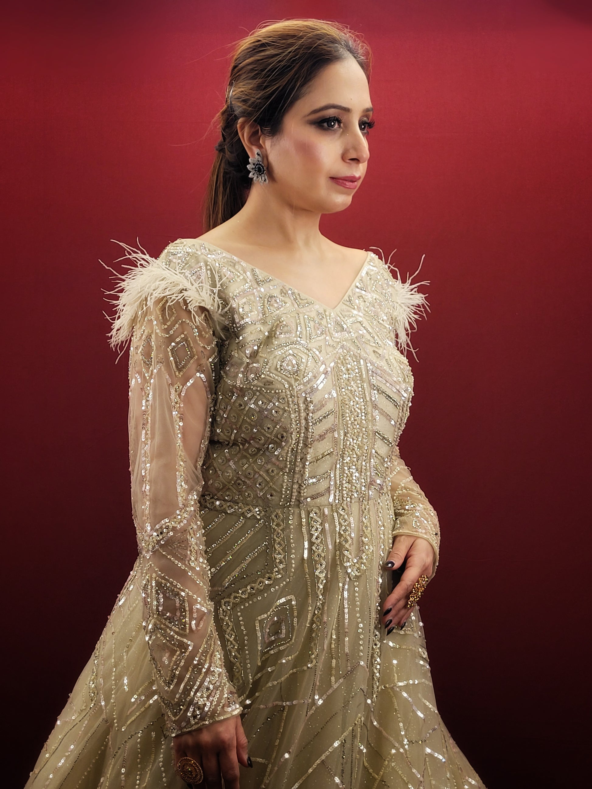 Imagine an Indian marriage dress in pista green, a symphony of beads, sequins and zarkan work, with a touch of luxury added by fur trimmed embroidered sleeves, all set against a backdrop of sheer net, perfect for engagement and reception festivities.