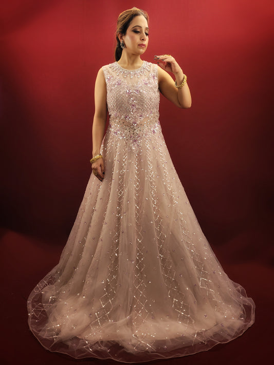 A vision in pink, this Indian wedding gown is a masterpiece of net fabric, intricately embellished with glass beads, sequins and zarkan, designed to dazzle at any reception or engagement ceremony.