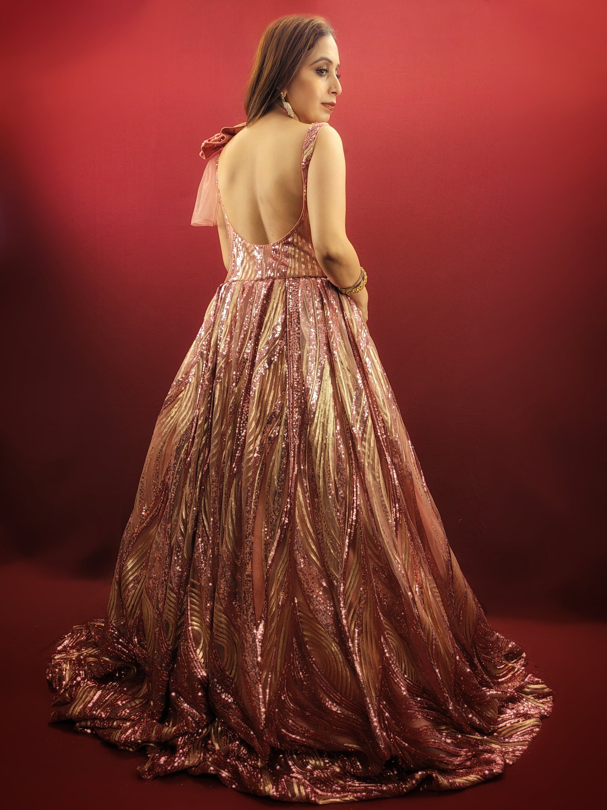 Step into your fairytale with our imported Gajri Pink Bridal Gown, adorned with sequins, beads and crystal flower on the shoulder, perfect for your engagement, cocktail or wedding day.