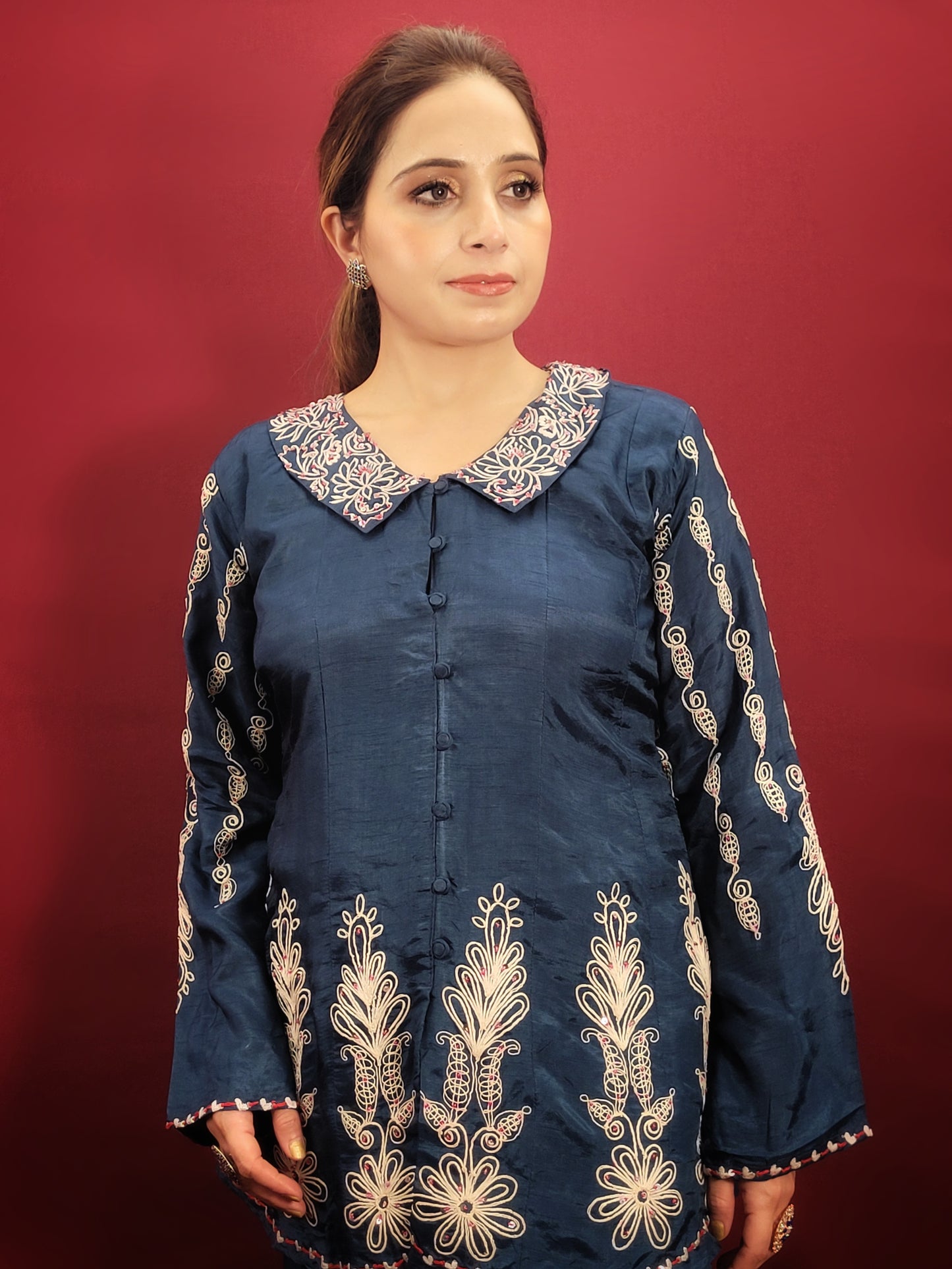 Make a statement in this stunning blue co-ord set, perfect for light parties and festive occasions. The breezy muslin fabric drapes beautifully, keeping you cool and comfortable throughout the night. The collared shirt adds a touch of sophistication, while the delicate resham and dori work with intricate cutwork on the pant mohri creates a uniquely eye-catching design.