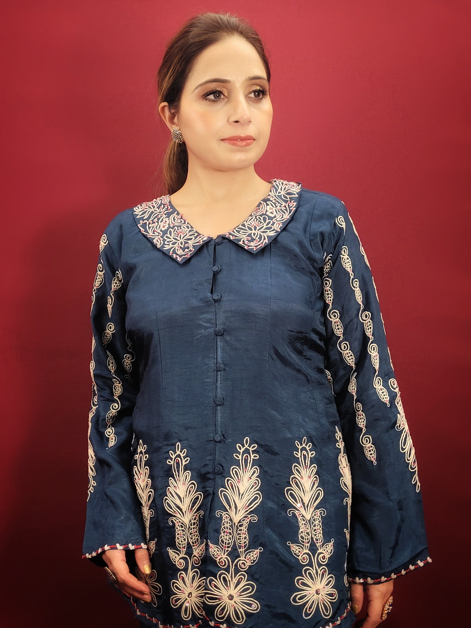 Make a statement in this stunning blue co-ord set, perfect for light parties and festive occasions. The breezy muslin fabric drapes beautifully, keeping you cool and comfortable throughout the night. The collared shirt adds a touch of sophistication, while the delicate resham and dori work with intricate cutwork on the pant mohri creates a uniquely eye-catching design.
