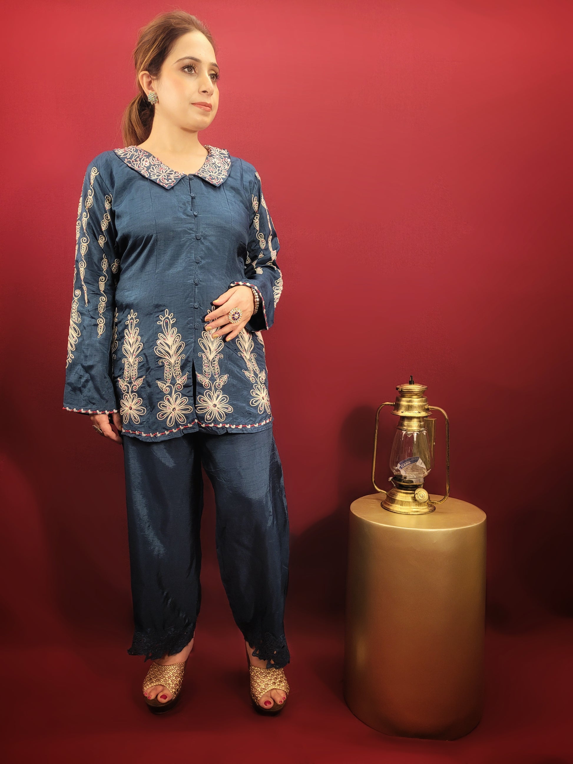 Make a statement in this stunning blue co-ord set, perfect for light parties and festive occasions. The breezy muslin fabric drapes beautifully, keeping you cool and comfortable throughout the night. The collared shirt adds a touch of sophistication, while the delicate resham and dori work with intricate cutwork on the pant mohri creates a uniquely eye-catching design.