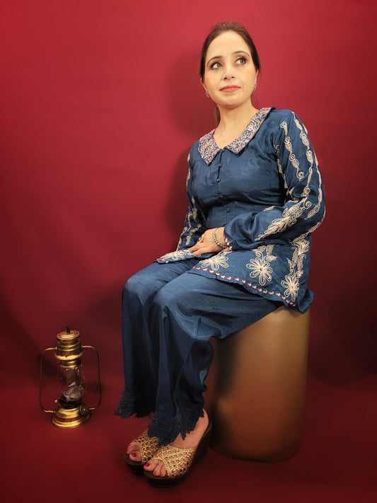 Make a statement in this stunning blue co-ord set, perfect for light parties and festive occasions. The breezy muslin fabric drapes beautifully, keeping you cool and comfortable throughout the night. The collared shirt adds a touch of sophistication, while the delicate resham and dori work with intricate cutwork on the pant mohri creates a uniquely eye-catching design.