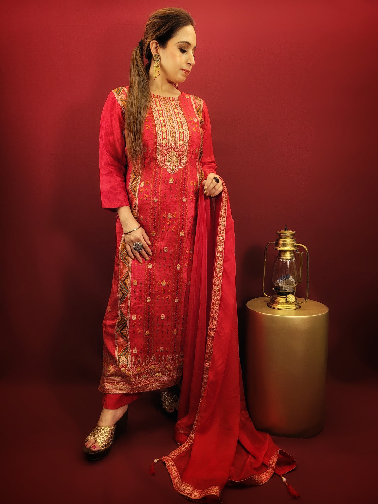 Add a touch of timeless elegance to your ethnic wear collection with this stunning red kurti pant dupatta set. The kurti boasts a beautiful multicolored Banarasi weave, intricately detailed with handwork that speaks volumes of Indian craftsmanship. Made from soft and breathable muslin, the kurti drapes beautifully, while the contrasting chiffon dupatta adds a touch of flowy grace.