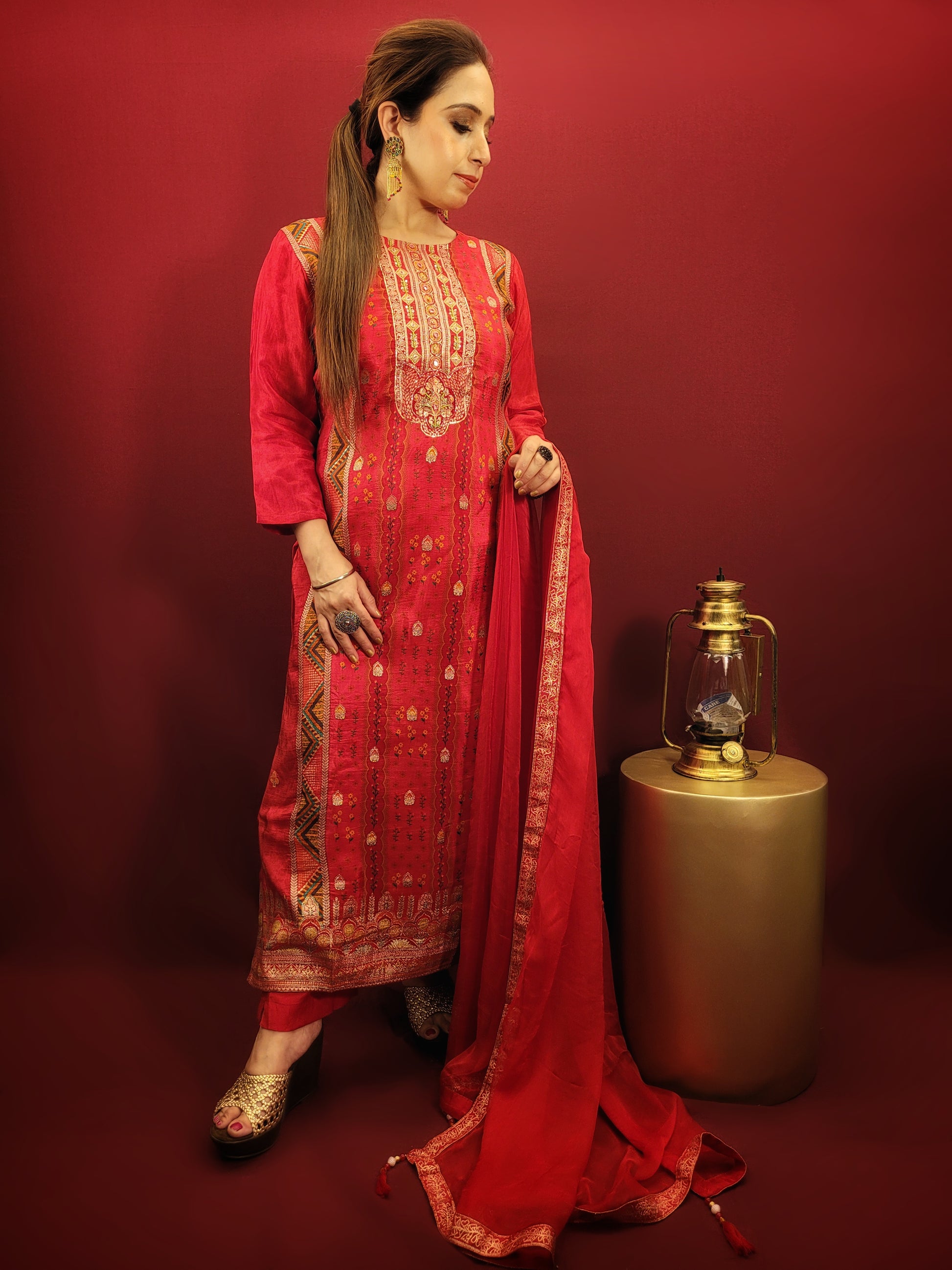 Add a touch of timeless elegance to your ethnic wear collection with this stunning red kurti pant dupatta set. The kurti boasts a beautiful multicolored Banarasi weave, intricately detailed with handwork that speaks volumes of Indian craftsmanship. Made from soft and breathable muslin, the kurti drapes beautifully, while the contrasting chiffon dupatta adds a touch of flowy grace.