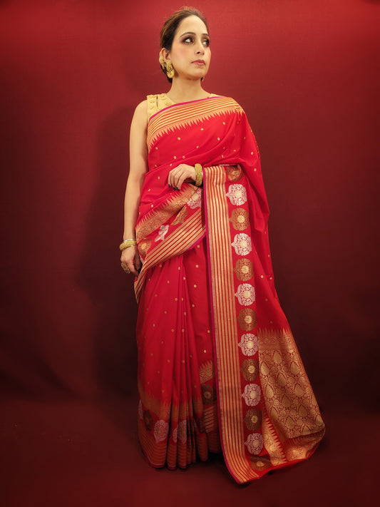 A lightweight banarsi saree in radiant red, perfect for reception and party wear, is a beautiful addition to a woman's ethnic wardrobe.