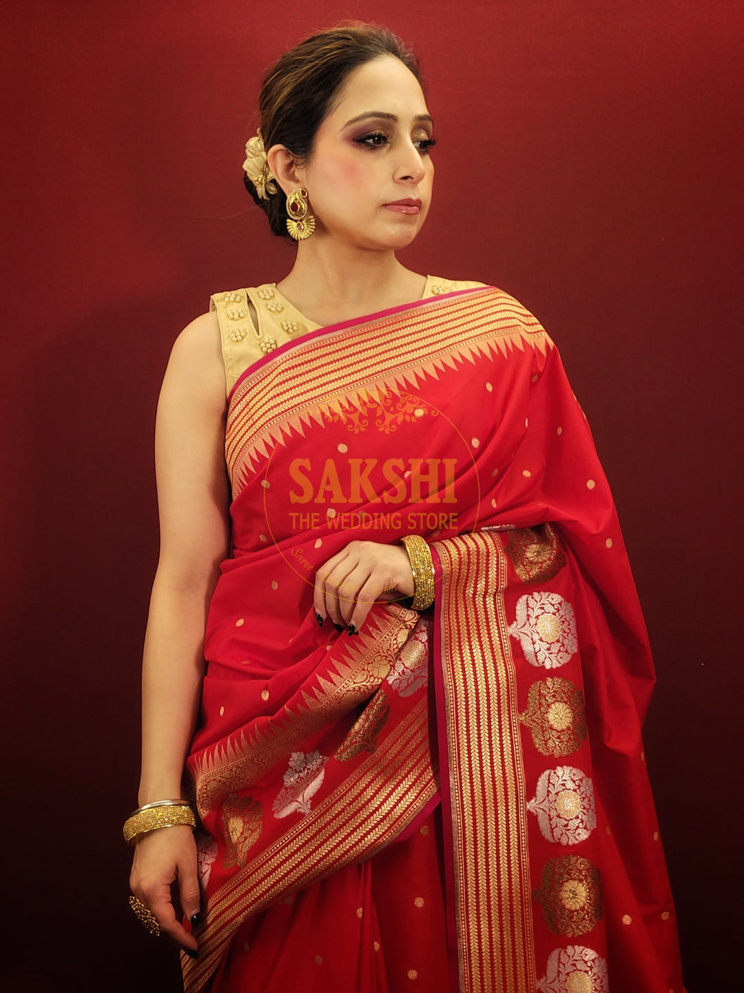 A lightweight banarsi saree in radiant red, perfect for reception and party wear, is a beautiful addition to a woman's ethnic wardrobe.