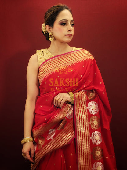 A lightweight banarsi saree in radiant red, perfect for reception and party wear, is a beautiful addition to a woman's ethnic wardrobe.