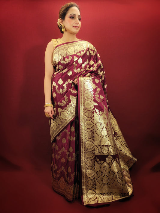 Embrace the grandeur of Indian weddings with a maroon Banarsi saree, adorned with zari woven artistry, perfect for party and wedding celebrations.