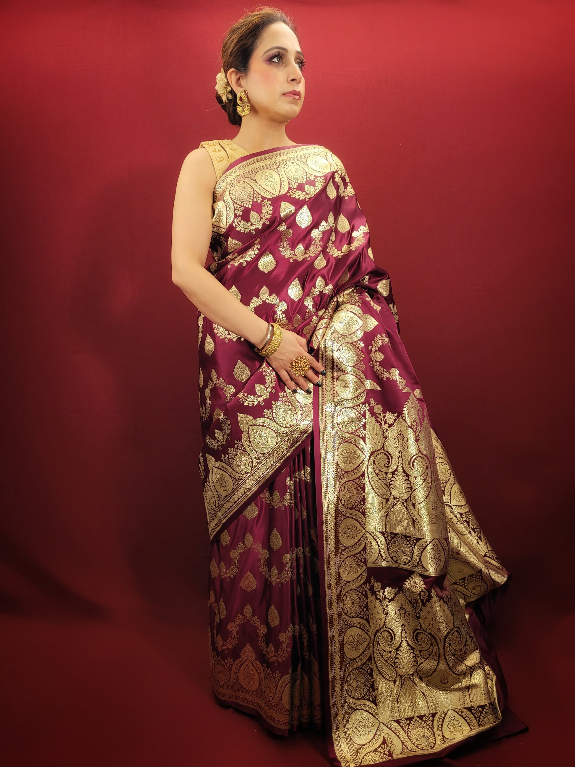 Embrace the grandeur of Indian weddings with a maroon Banarsi saree, adorned with zari woven artistry, perfect for party and wedding celebrations.