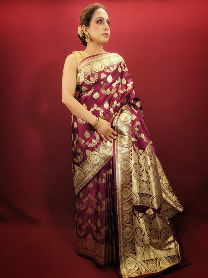 Embrace the grandeur of Indian weddings with a maroon Banarsi saree, adorned with zari woven artistry, perfect for party and wedding celebrations.
