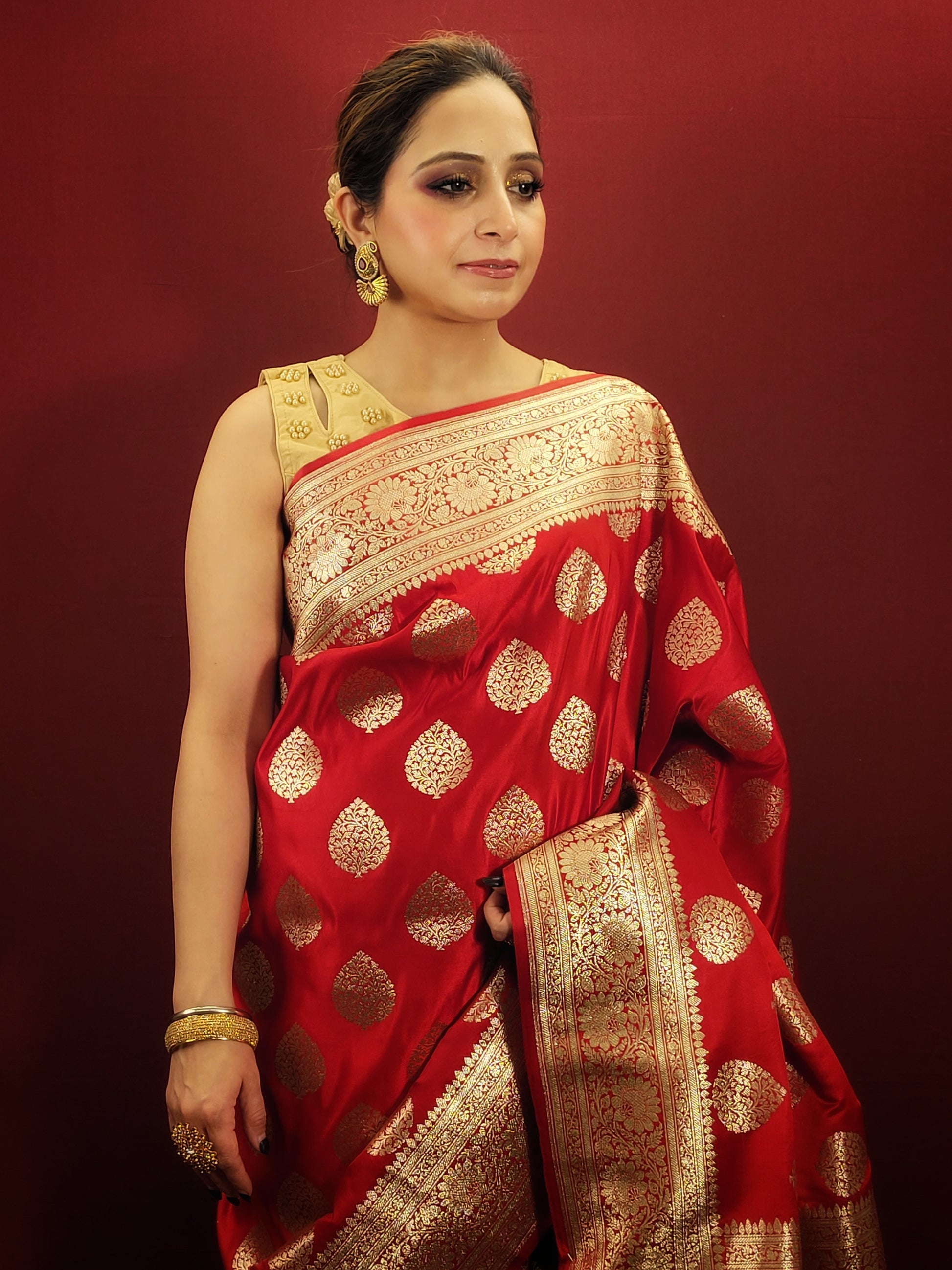 A red banarsi saree, with its zari woven splendor, is a quintessential wedding and party attire, epitomizing the richness of women's ethnic wear.
