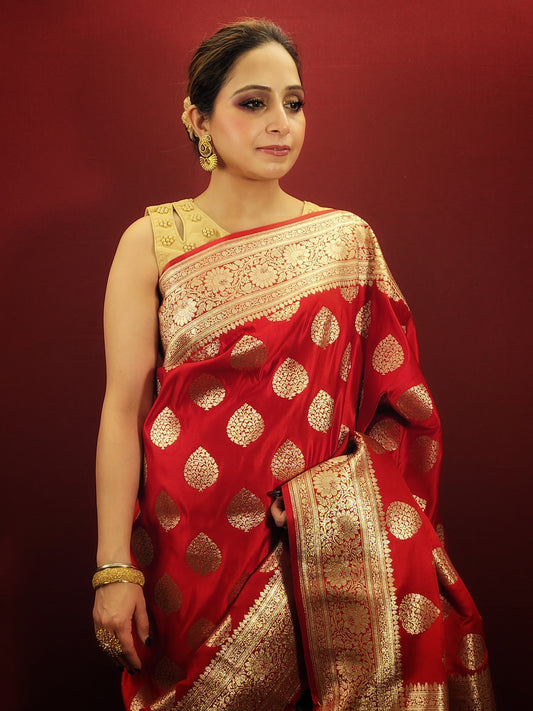 A red banarsi saree, with its zari woven splendor, is a quintessential wedding and party attire, epitomizing the richness of women's ethnic wear.