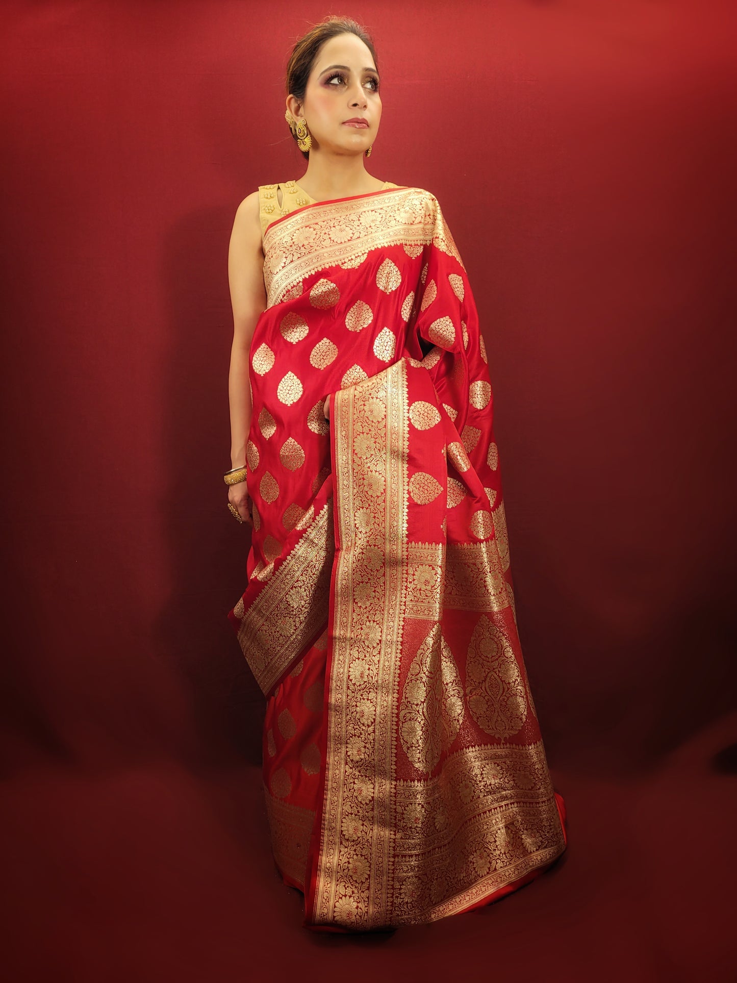 A red banarsi saree, with its zari woven splendor, is a quintessential wedding and party attire, epitomizing the richness of women's ethnic wear.