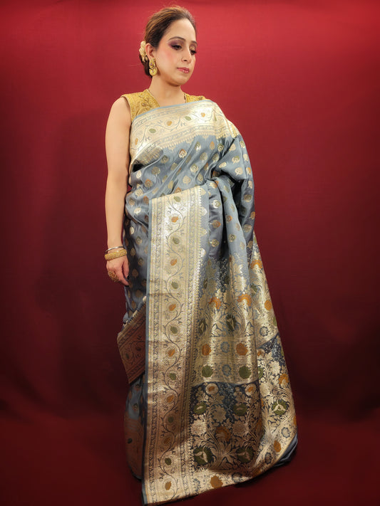 This silver grey banarasi saree, with its intricately woven alfi zari, is a pure handloom masterpiece that epitomises Indian ethnic elegance.