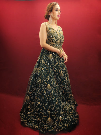 A bottle green gown, richly adorned with zari, dori & mirror work, makes for an exquisite choice for cocktail and reception ceremonies, perfectly complementing the mehendi vibrant hues.