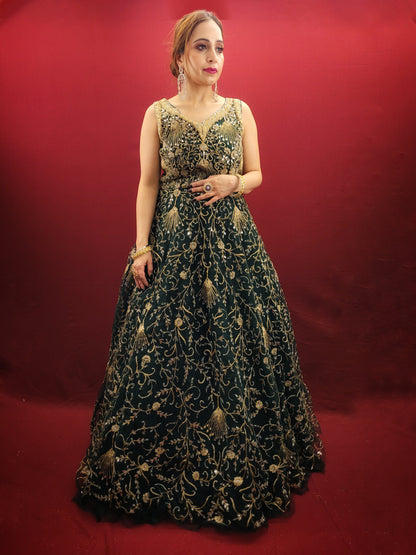 A bottle green gown, richly adorned with zari, dori & mirror work, makes for an exquisite choice for cocktail and reception ceremonies, perfectly complementing the mehendi vibrant hues.