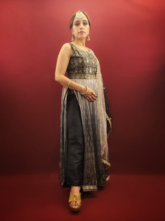 The Nayra suit, with its graceful grey ombre setting and chic Pant Set, is accentuated with traditional block prints and sparkling zarkan, crafted from flowing chinnon, making it a sophisticated ethnic ensemble  for women's party wear.