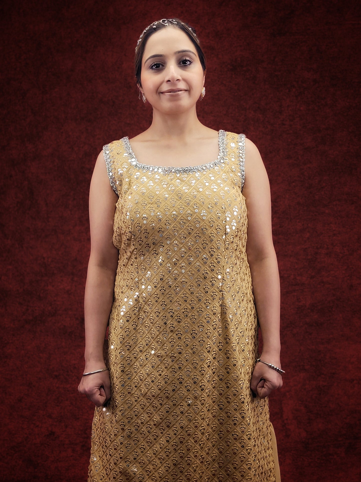 Embrace elegance with a golden beige kameez adorned with delicate sequins and thread work, paired with a gharara, for a stunning ethnic wear ensemble, ideal for party and festive occasions.