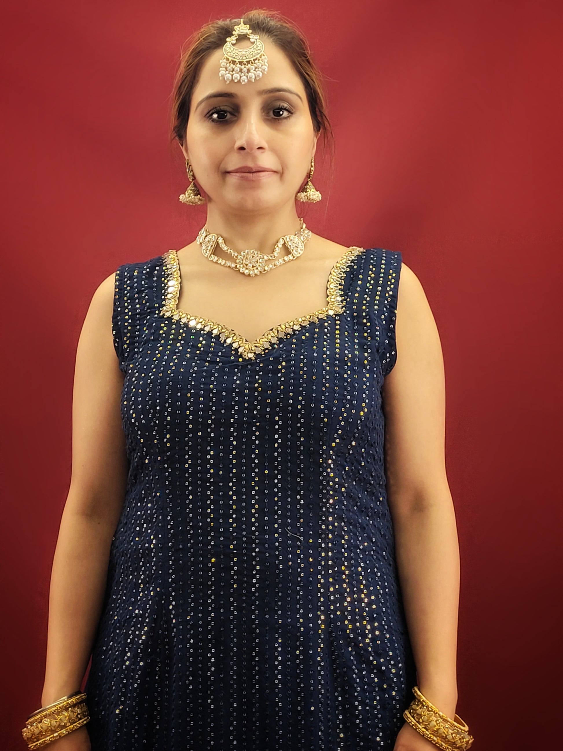 Radiate sophistication with a Prussian blue gharara kameez, featuring elegant thread and sequins embroidery on georgette fabric, an ethnic dress that's a showstopper for party and festive wear.