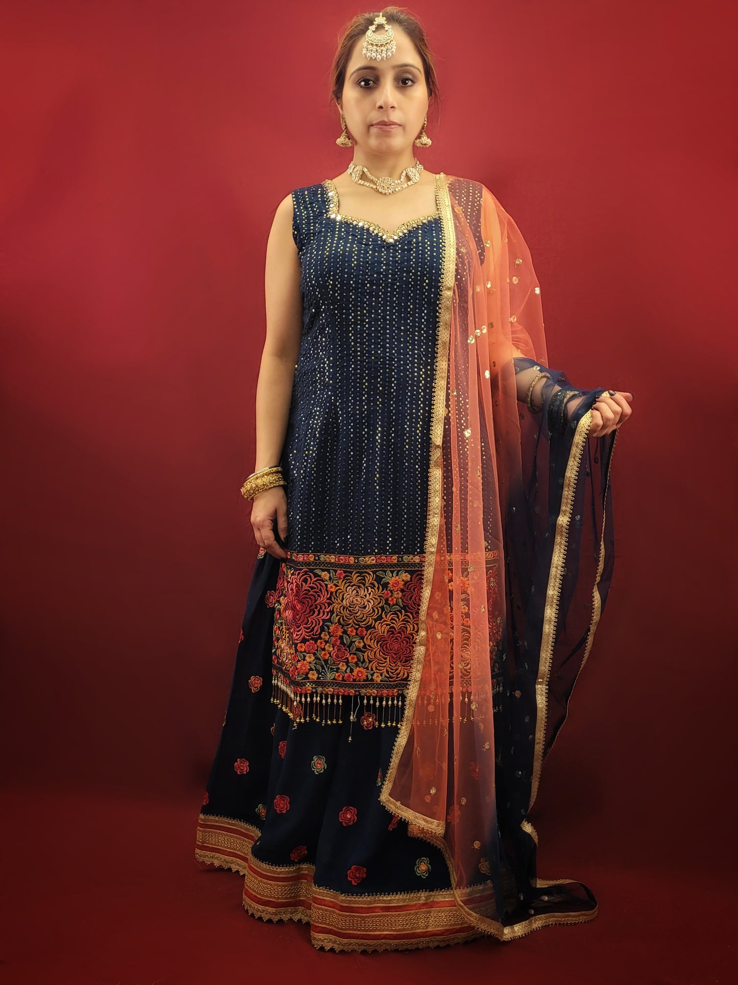 Radiate sophistication with a Prussian blue gharara kameez, featuring elegant thread and sequins embroidery on georgette fabric, an ethnic dress that's a showstopper for party and festive wear.
