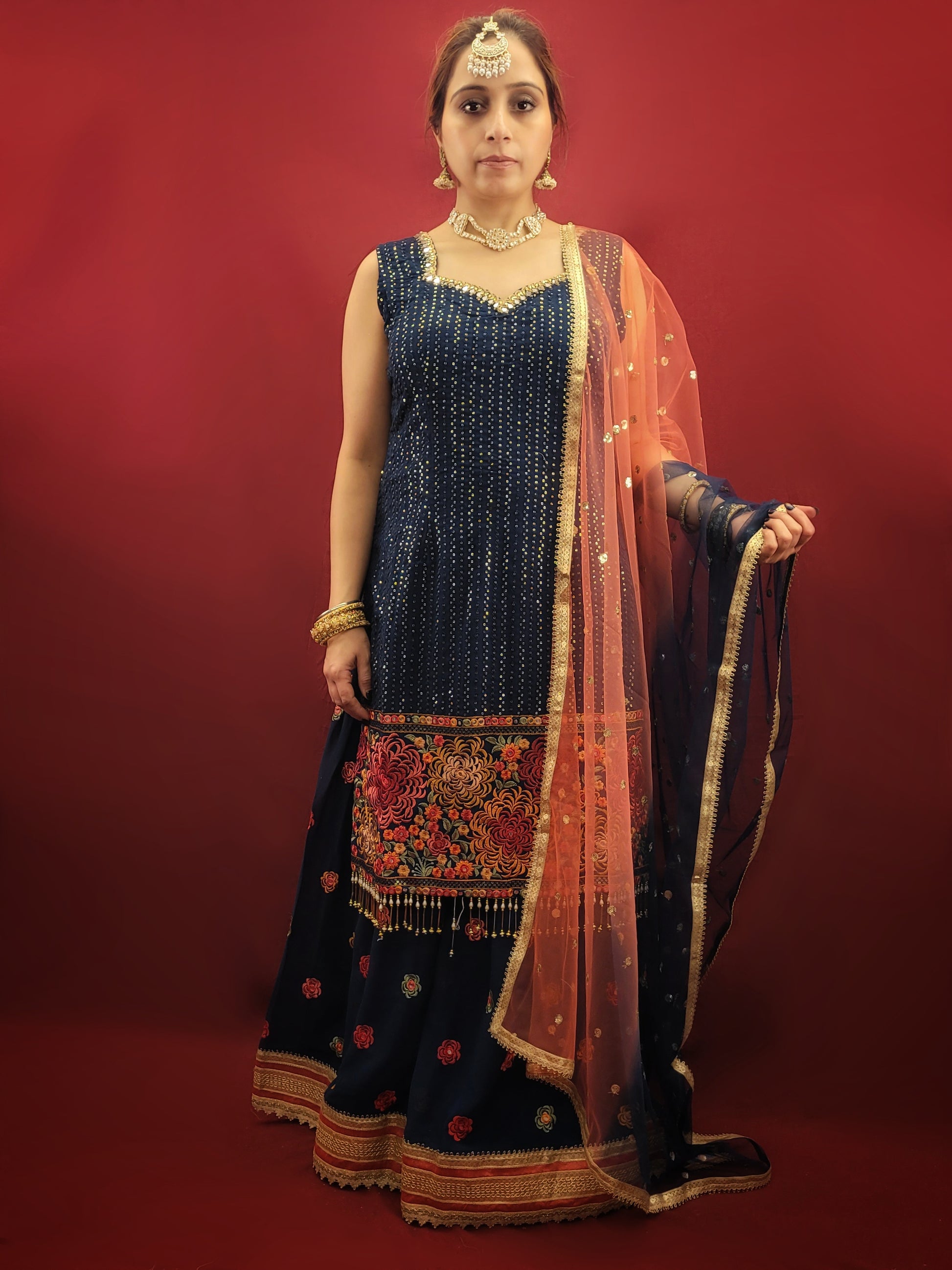 Radiate sophistication with a Prussian blue gharara kameez, featuring elegant thread and sequins embroidery on georgette fabric, an ethnic dress that's a showstopper for party and festive wear.