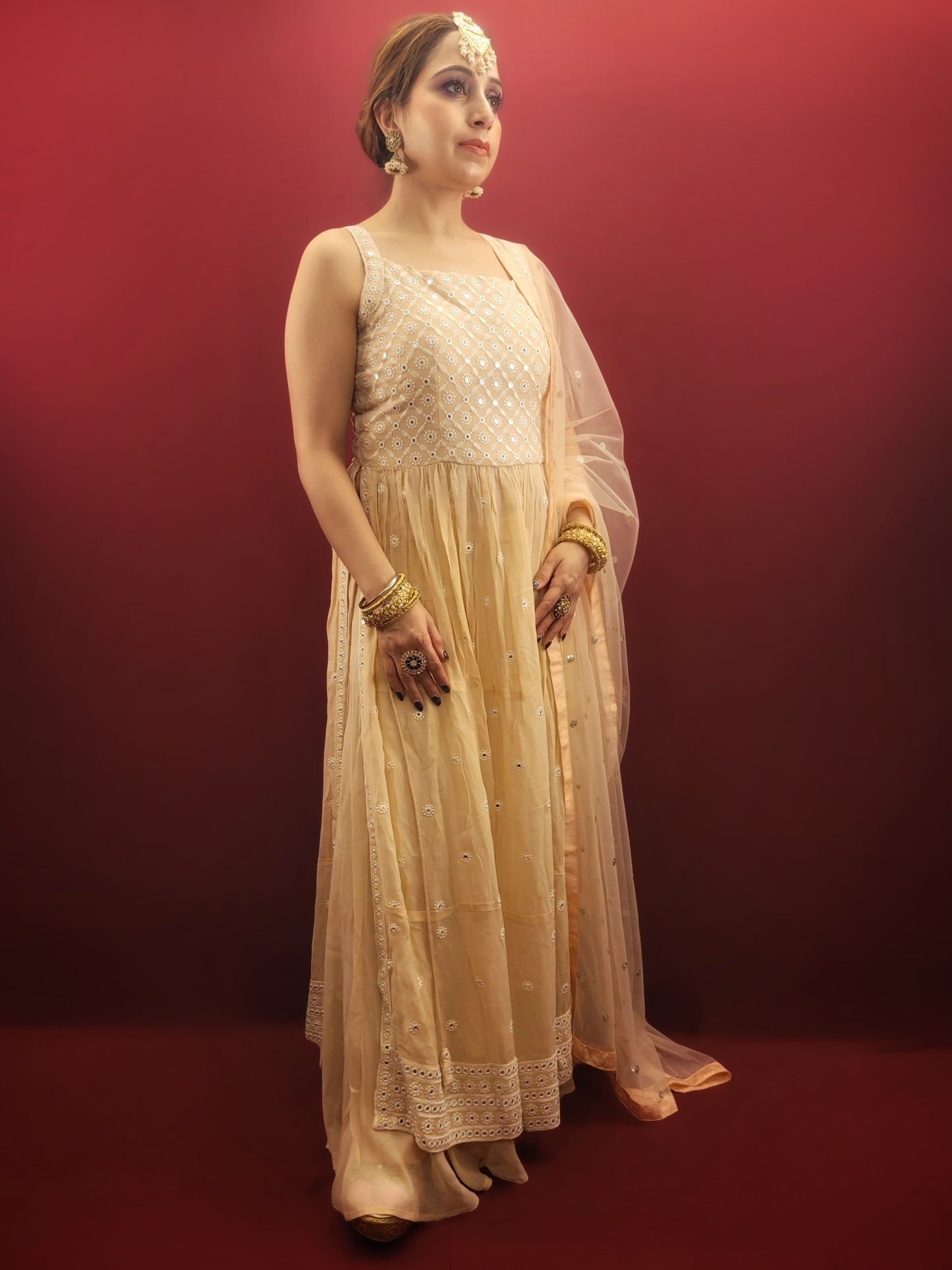 Discover the grace of light peach in this Nayra Kameez Palazzo Set, crafted with delicate chikan threadwork on georgette, an ideal ensemble for party and festive occasions.