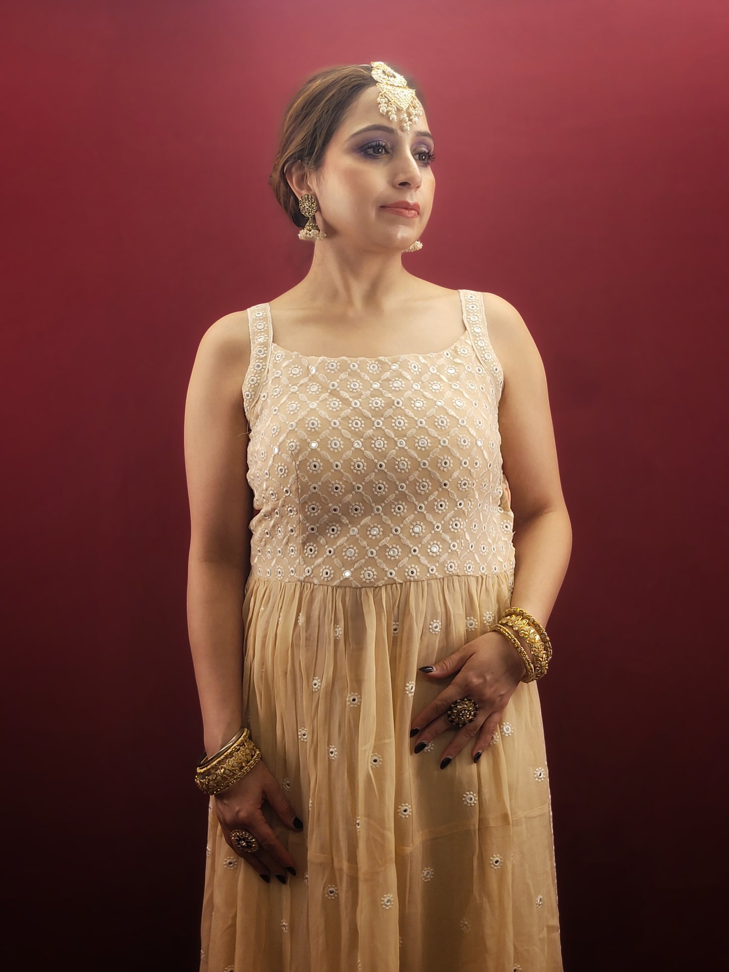 Discover the grace of light peach in this Nayra Kameez Palazzo Set, crafted with delicate chikan threadwork on georgette, an ideal ensemble for party and festive occasions.