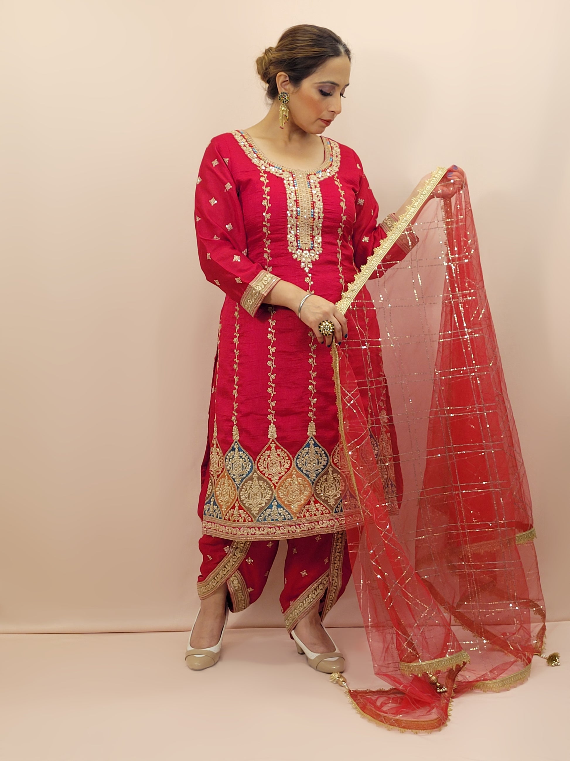 Red Embroidered Salwar Kameez Set, a perfect blend of tradition and modernity. This exquisite ensemble features a radiant Red kameez adorned with intricate embroidery and sparkling dori-sequins work around the neckline and hemline. The vibrant patterns in multiple colors add a touch of festivity and charm, making it ideal for any special occasion.