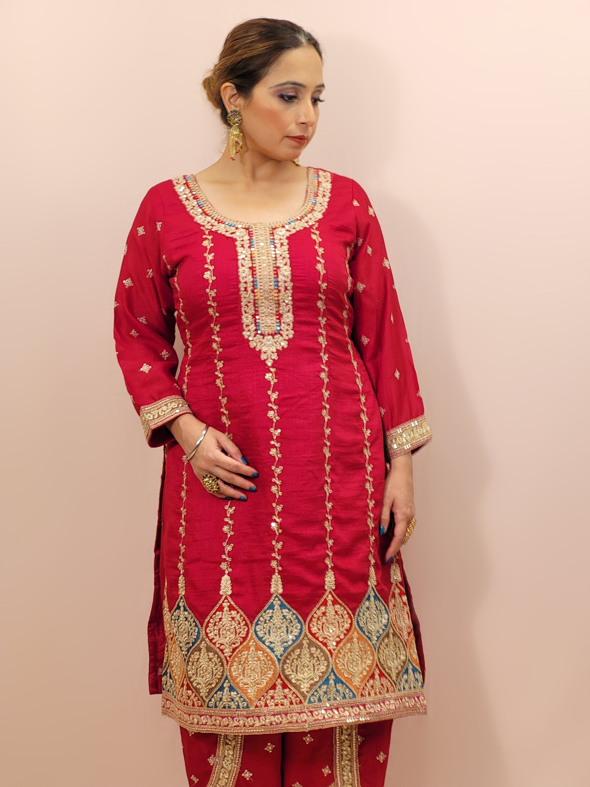 Red Embroidered Salwar Kameez Set, a perfect blend of tradition and modernity. This exquisite ensemble features a radiant Red kameez adorned with intricate embroidery and sparkling dori-sequins work around the neckline and hemline. The vibrant patterns in multiple colors add a touch of festivity and charm, making it ideal for any special occasion.