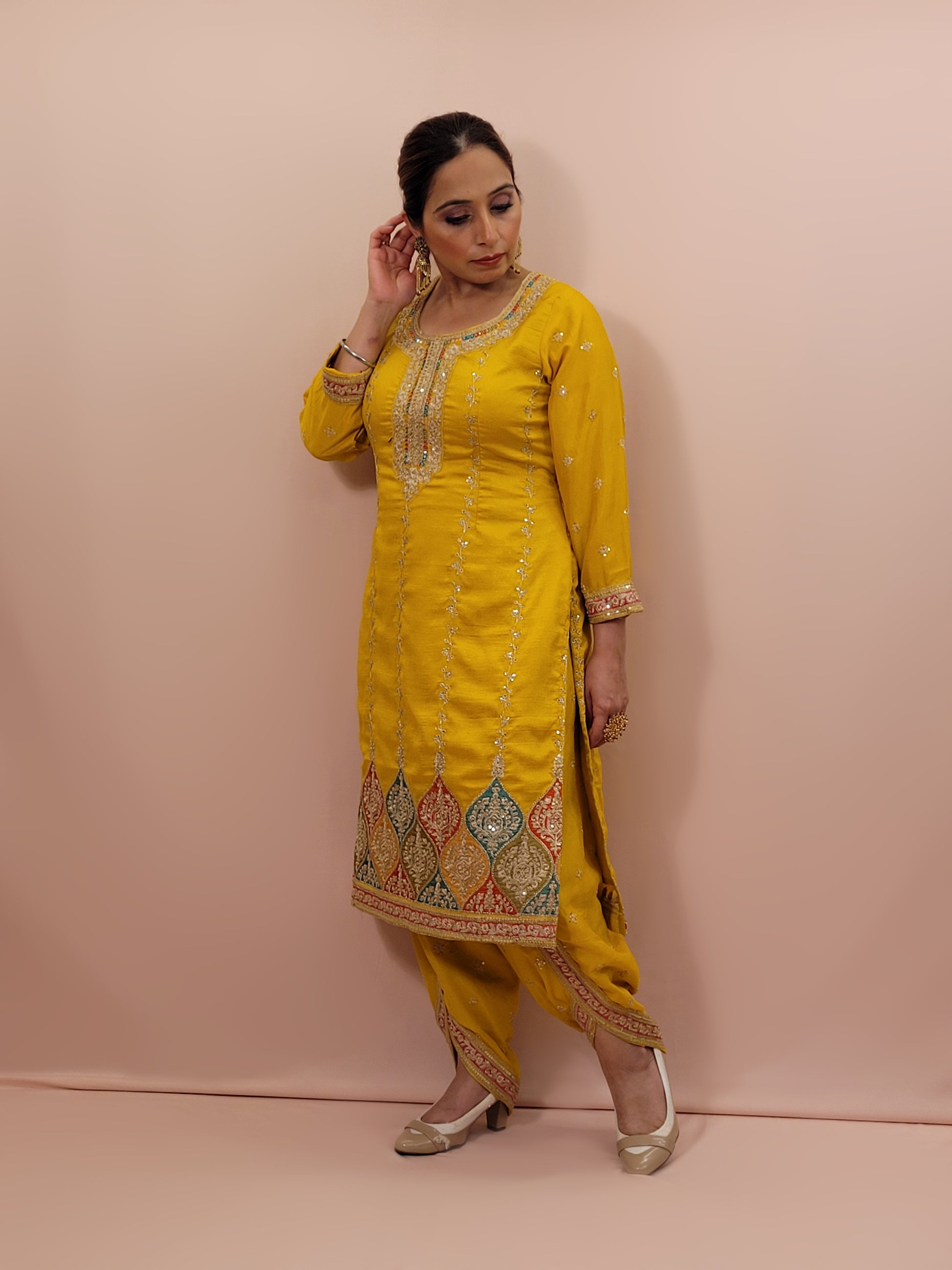 The long-sleeved kameez is paired with a simple yet sophisticated salwar, providing a balanced look that complements the ornate top. Completing the outfit is a matching yellow dupatta, embellished with similar embroidery and beadwork along its borders, adding a graceful touch to your attire.