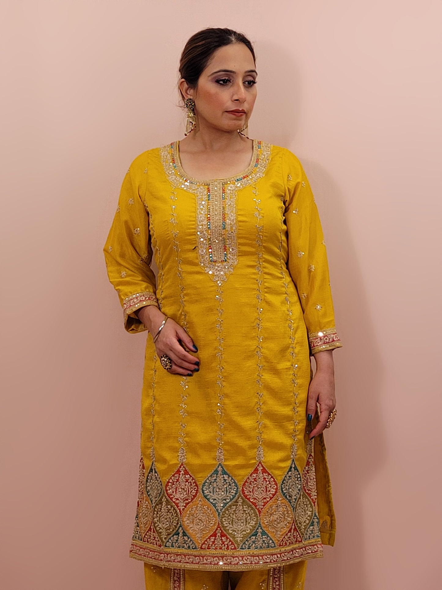 The long-sleeved kameez is paired with a simple yet sophisticated salwar, providing a balanced look that complements the ornate top. Completing the outfit is a matching yellow dupatta, embellished with similar embroidery and beadwork along its borders, adding a graceful touch to your attire.