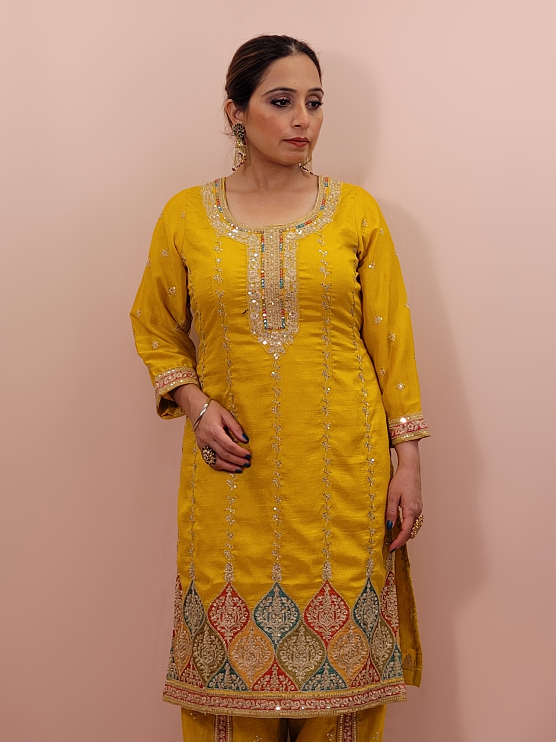The long-sleeved kameez is paired with a simple yet sophisticated salwar, providing a balanced look that complements the ornate top. Completing the outfit is a matching yellow dupatta, embellished with similar embroidery and beadwork along its borders, adding a graceful touch to your attire.