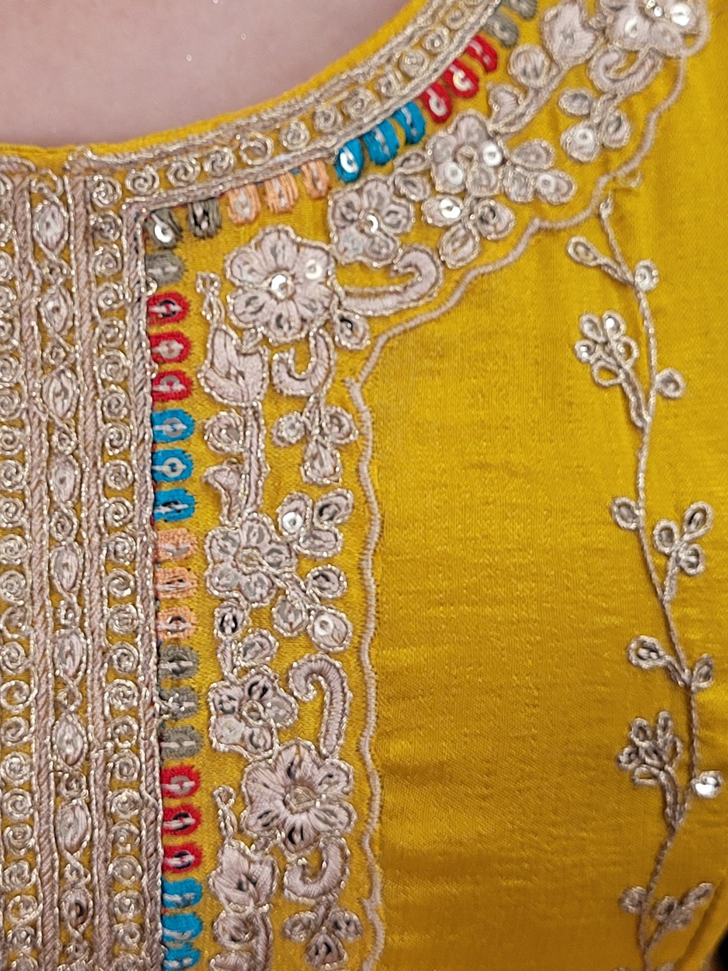 The long-sleeved kameez is paired with a simple yet sophisticated salwar, providing a balanced look that complements the ornate top. Completing the outfit is a matching yellow dupatta, embellished with similar embroidery and beadwork along its borders, adding a graceful touch to your attire.