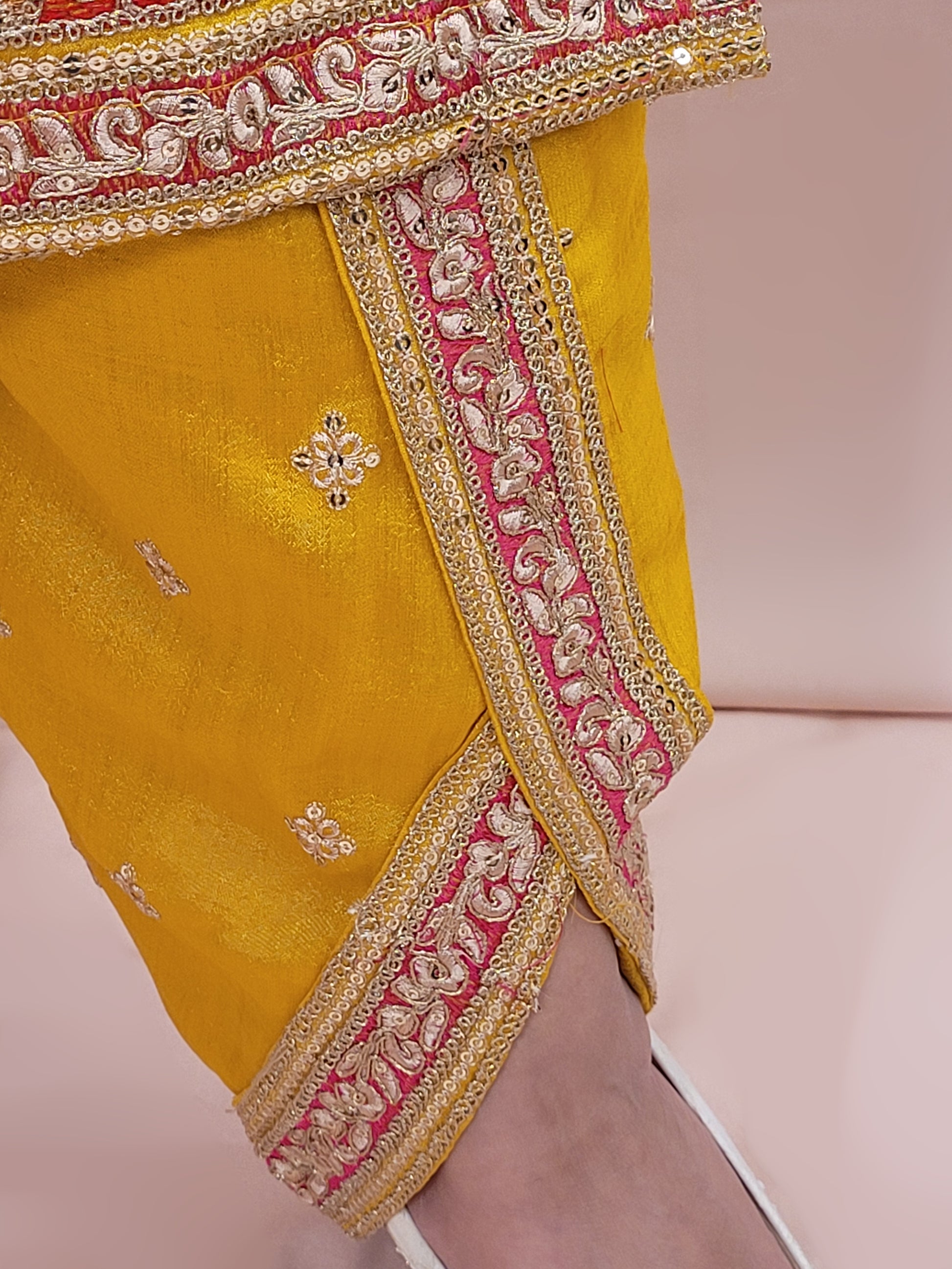 The long-sleeved kameez is paired with a simple yet sophisticated salwar, providing a balanced look that complements the ornate top. Completing the outfit is a matching yellow dupatta, embellished with similar embroidery and beadwork along its borders, adding a graceful touch to your attire.
