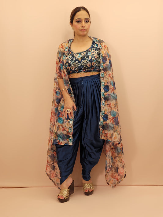 The blouse is adorned with vibrant resham embroidery, creating a tapestry of traditional artistry on a contemporary silhouette. The tulip pants provide a chic and comfortable fit, perfect for modern fashionistas. The digital multicolored print shrug adds a bold statement to the ensemble, with its vibrant hues and unique patterns.