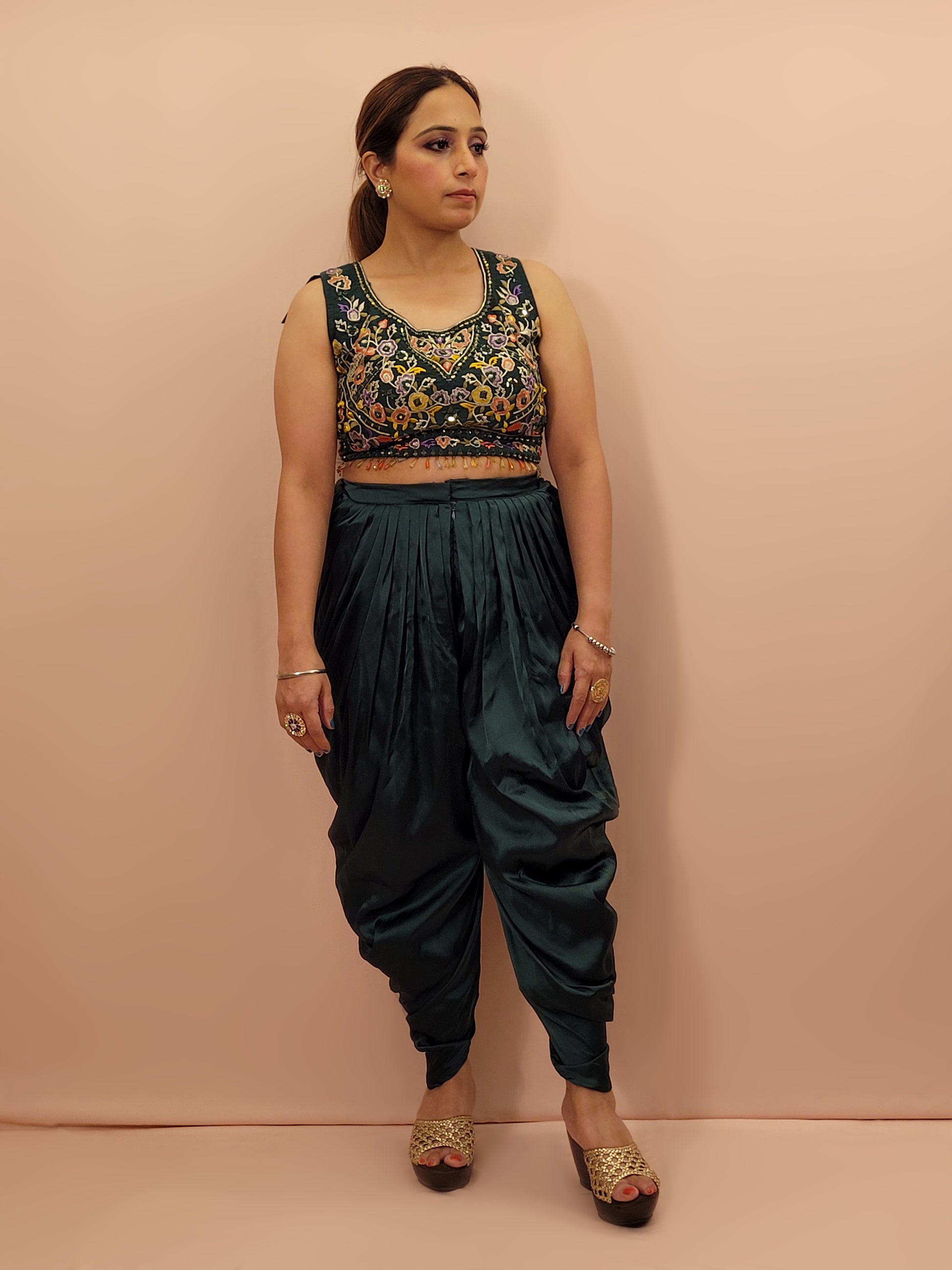 The blouse is adorned with vibrant resham embroidery, creating a tapestry of traditional artistry on a contemporary silhouette. The tulip pants provide a chic and comfortable fit, perfect for modern fashionistas. The digital multicolored print shrug adds a bold statement to the ensemble, with its vibrant hues and unique patterns.