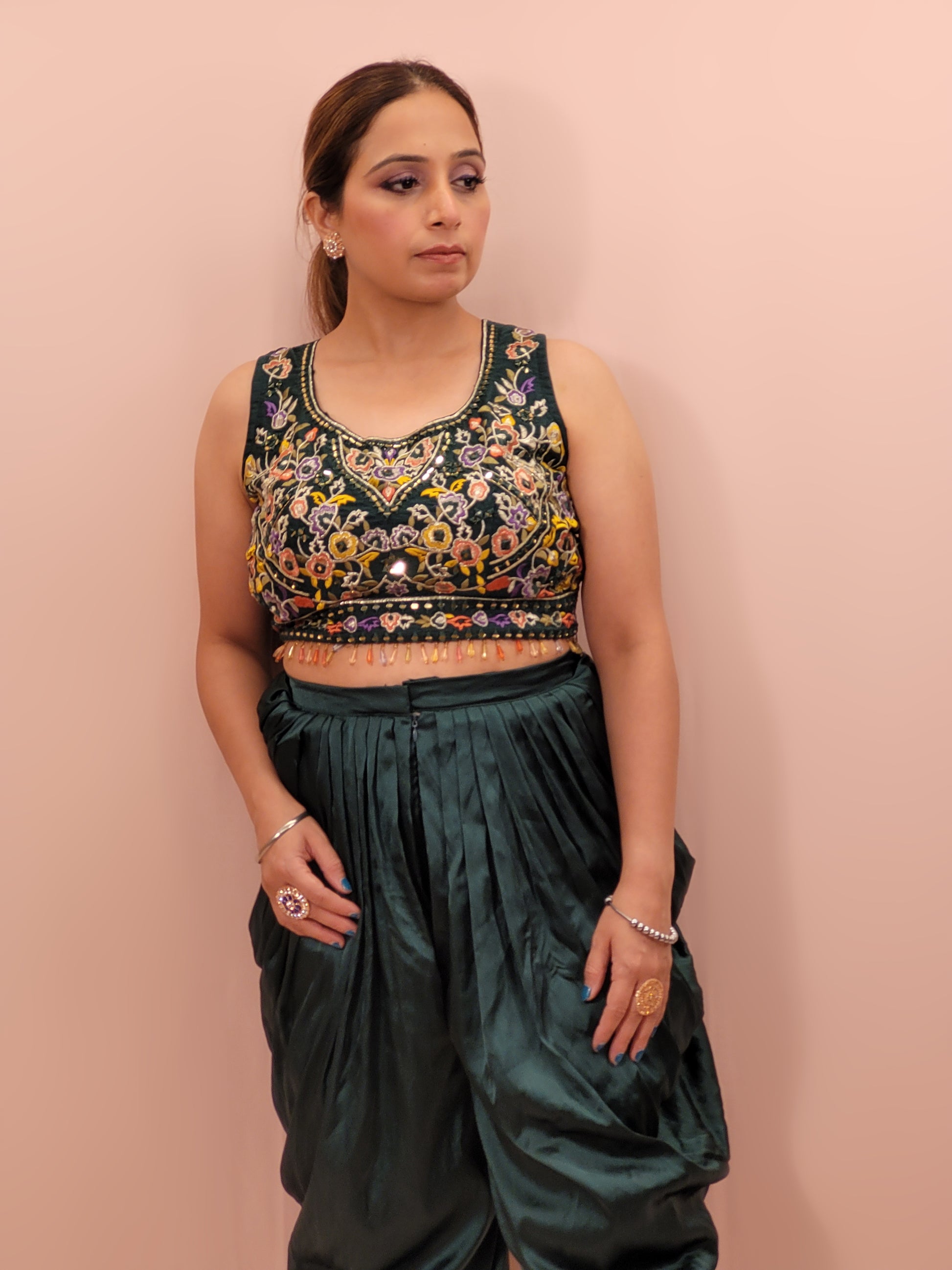 The blouse is adorned with vibrant resham embroidery, creating a tapestry of traditional artistry on a contemporary silhouette. The tulip pants provide a chic and comfortable fit, perfect for modern fashionistas. The digital multicolored print shrug adds a bold statement to the ensemble, with its vibrant hues and unique patterns.