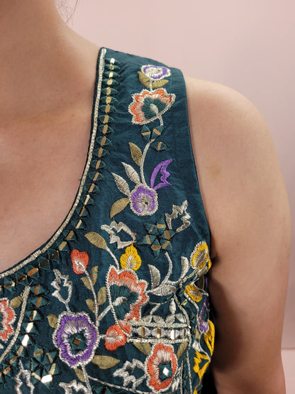 The blouse is adorned with vibrant resham embroidery, creating a tapestry of traditional artistry on a contemporary silhouette. The tulip pants provide a chic and comfortable fit, perfect for modern fashionistas. The digital multicolored print shrug adds a bold statement to the ensemble, with its vibrant hues and unique patterns.