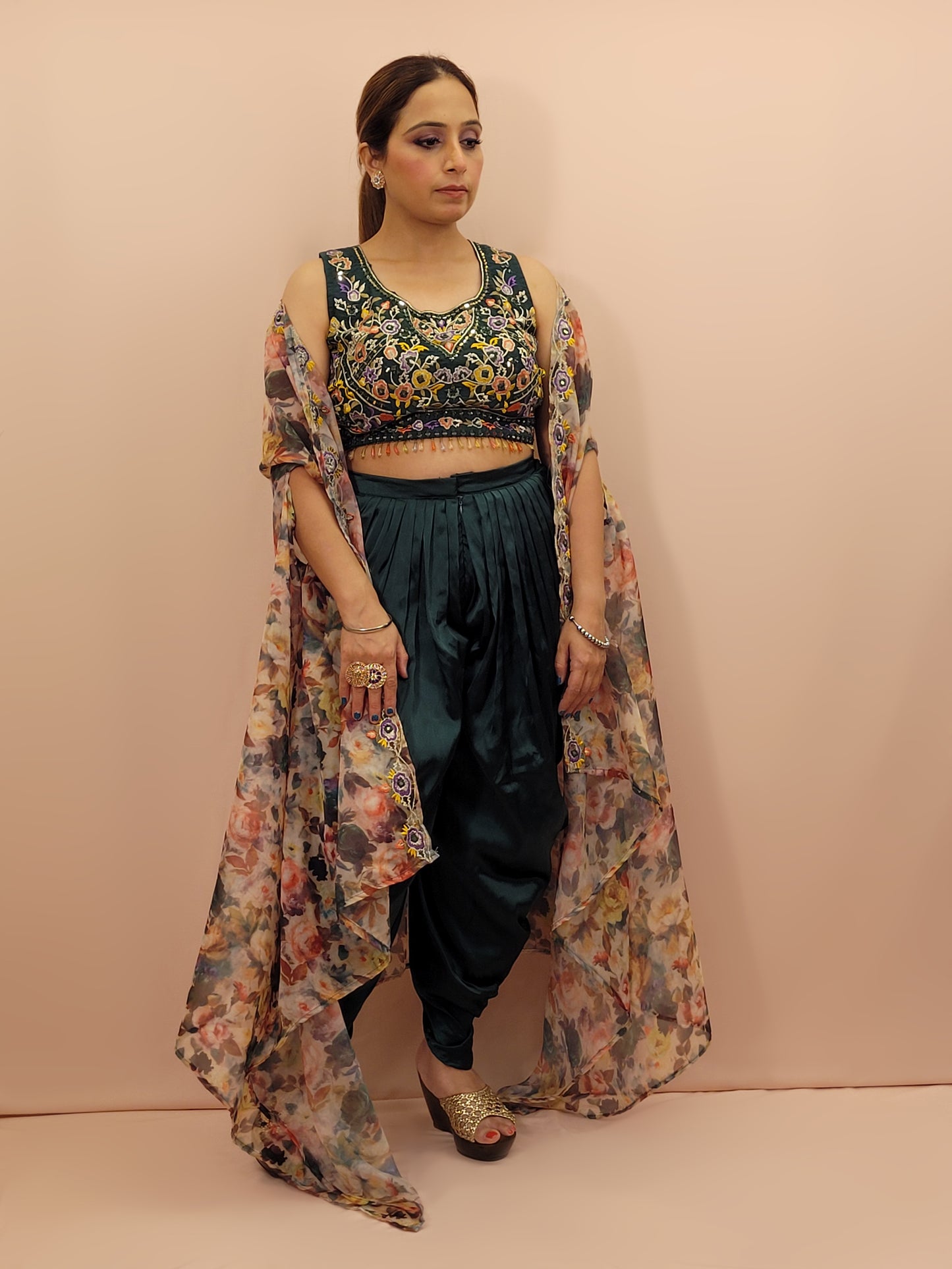 The blouse is adorned with vibrant resham embroidery, creating a tapestry of traditional artistry on a contemporary silhouette. The tulip pants provide a chic and comfortable fit, perfect for modern fashionistas. The digital multicolored print shrug adds a bold statement to the ensemble, with its vibrant hues and unique patterns.